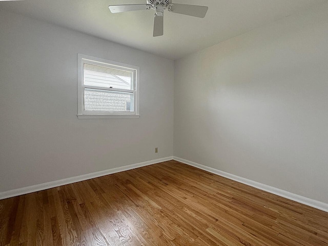 spare room featuring wood-type flooring and ceiling fan