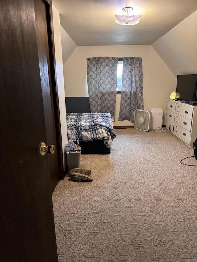 carpeted bedroom with vaulted ceiling