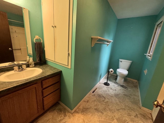 bathroom featuring vanity and toilet