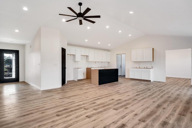 kitchen featuring white cabinetry, light hardwood / wood-style floors, and a center island