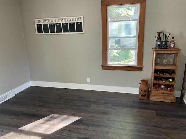 empty room featuring dark hardwood / wood-style flooring