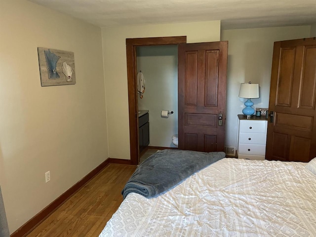 bedroom featuring ensuite bathroom and light hardwood / wood-style flooring