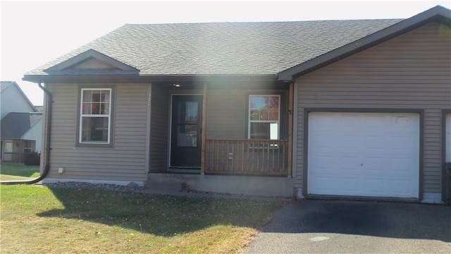 view of front of home with a front lawn, a porch, and a garage