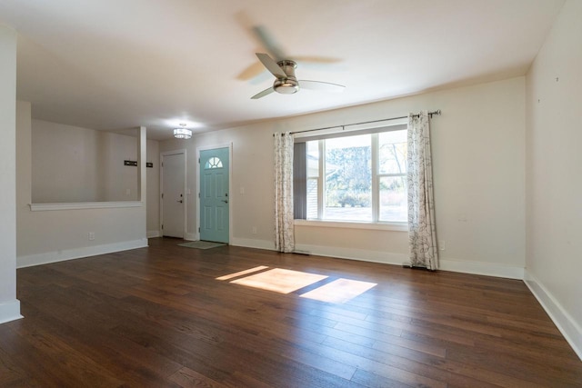 spare room featuring dark wood-type flooring and ceiling fan