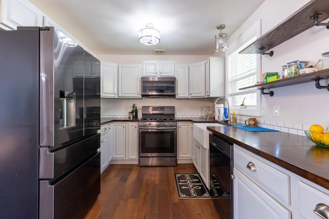 kitchen featuring dark wood-type flooring, wood counters, white cabinetry, and appliances with stainless steel finishes