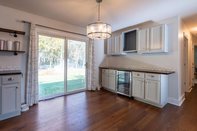 kitchen featuring white cabinetry, pendant lighting, and wine cooler