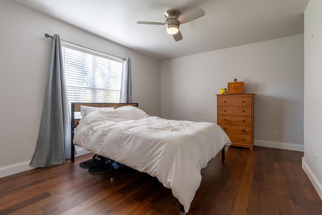 bedroom with dark hardwood / wood-style flooring and ceiling fan