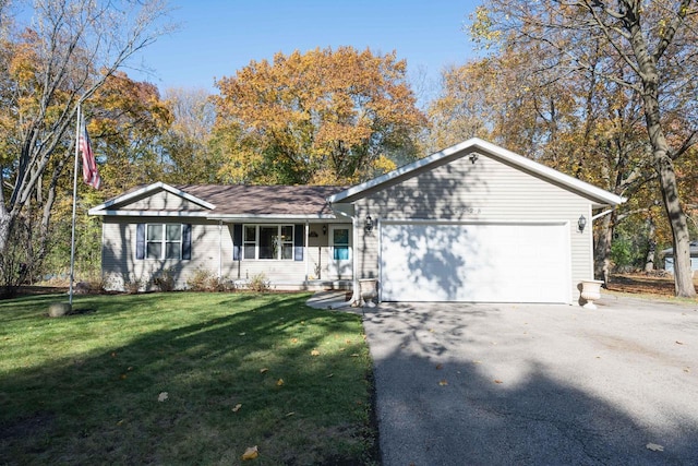 single story home with covered porch, a garage, and a front yard