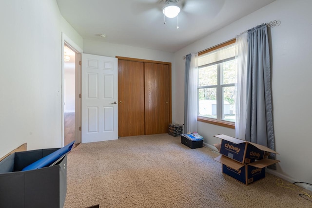 misc room with carpet flooring and ceiling fan