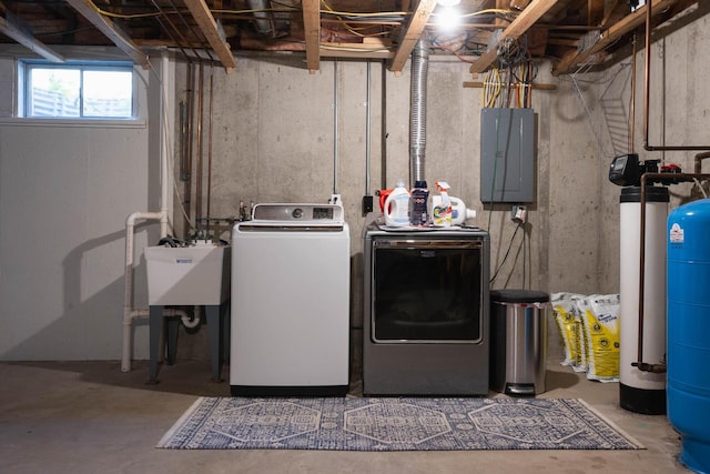 washroom featuring electric panel, sink, and washer and dryer