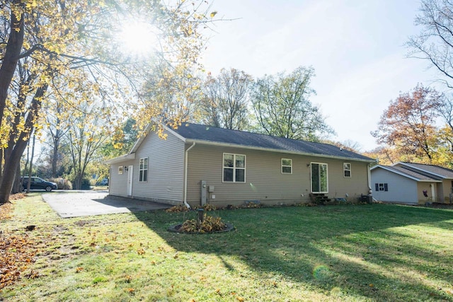 back of house with a patio area and a lawn