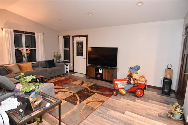 living room featuring hardwood / wood-style flooring and vaulted ceiling