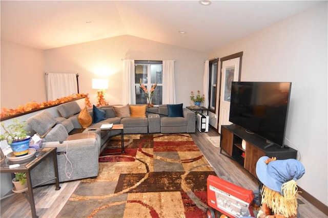 living room with hardwood / wood-style floors and lofted ceiling