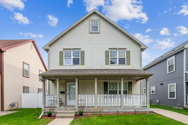 front of property with a front yard and covered porch