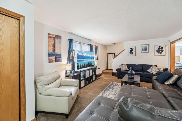 living room featuring a textured ceiling and carpet flooring