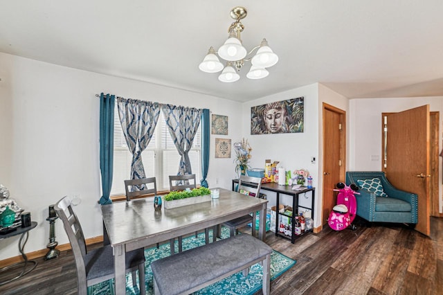 dining room with dark wood-type flooring and a notable chandelier