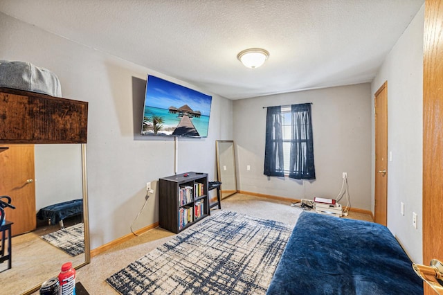 carpeted bedroom featuring a textured ceiling