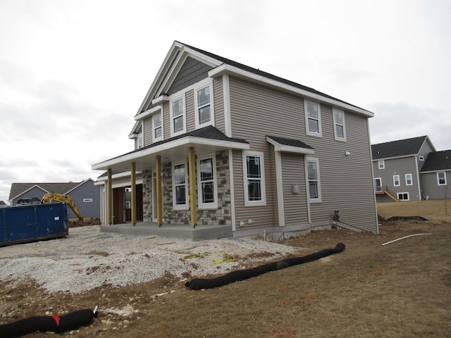 1581 Creekview Ln, Oconomowoc, WI 53066 - back of house featuring a porch and stone siding