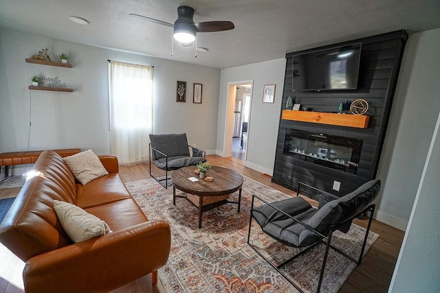 living room featuring hardwood / wood-style floors and ceiling fan