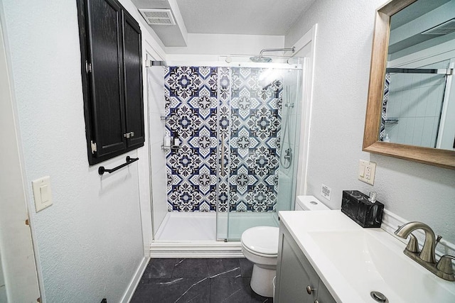 bathroom featuring a shower with door, vanity, toilet, and a textured ceiling