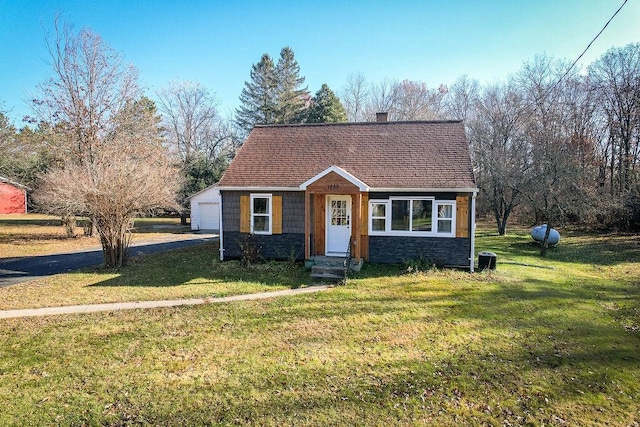 view of front of home featuring a garage and a front lawn