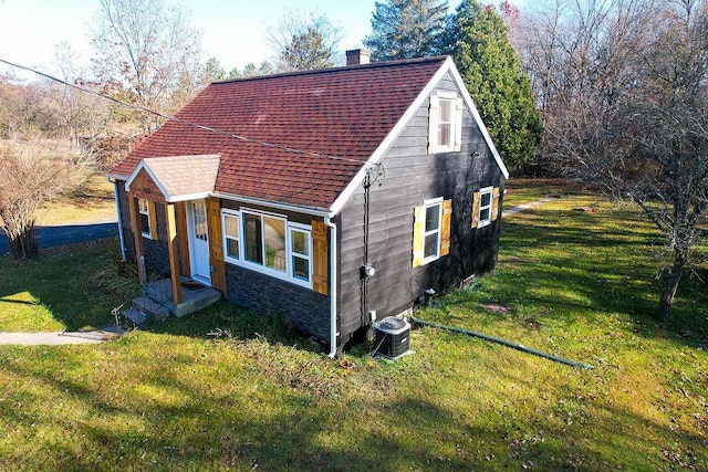 view of side of home with a yard