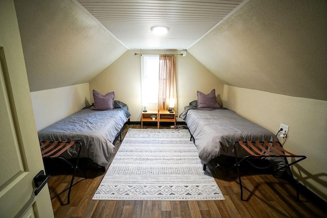 bedroom featuring hardwood / wood-style flooring and vaulted ceiling