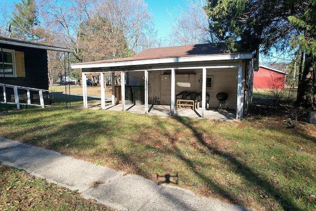 back of property featuring a patio area and a yard