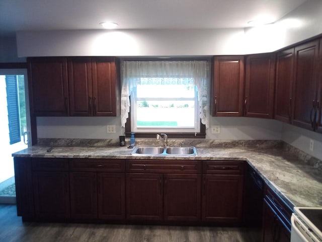 kitchen featuring dark wood-type flooring, sink, and black dishwasher