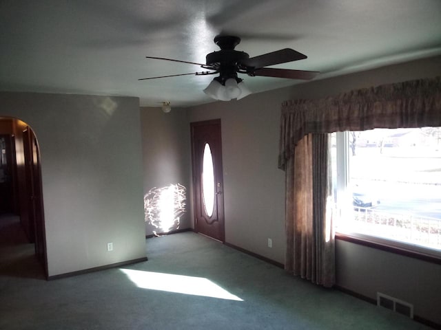 interior space with ceiling fan and carpet