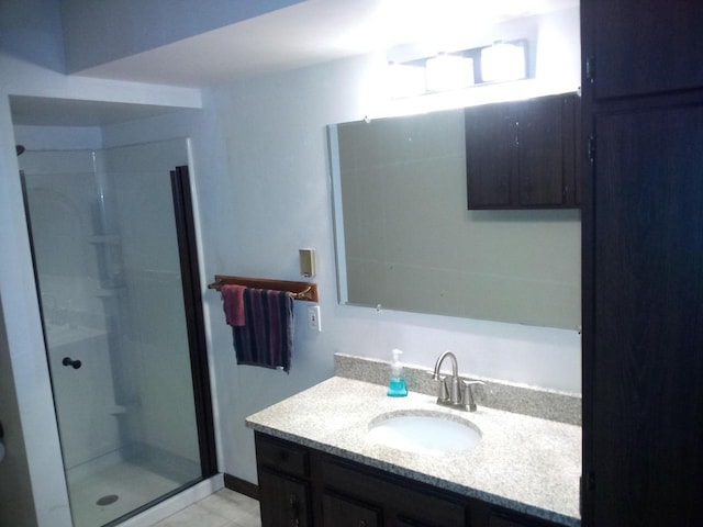 bathroom with vanity and a shower