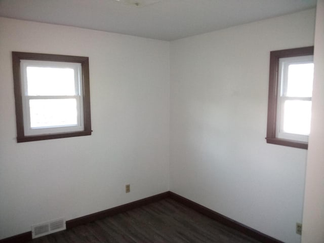 spare room with dark hardwood / wood-style flooring