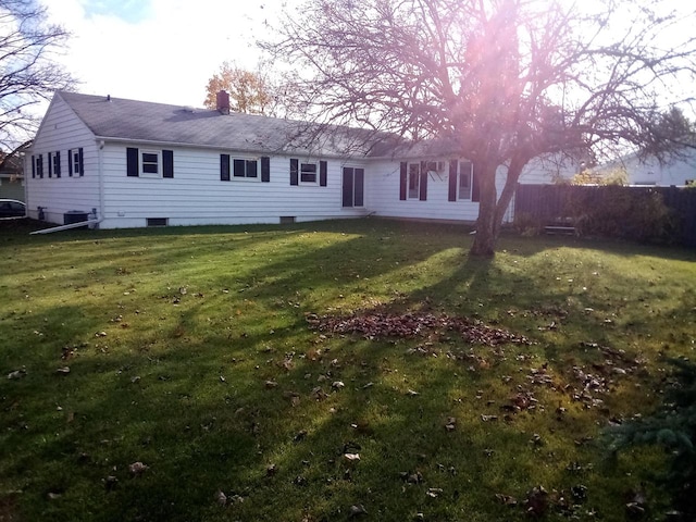 back of house with a lawn