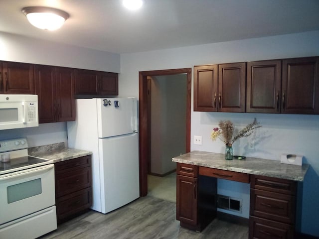 kitchen featuring white appliances and wood-type flooring