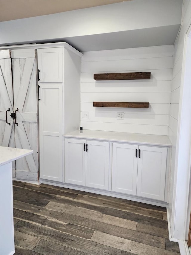 bar featuring white cabinets and dark hardwood / wood-style floors