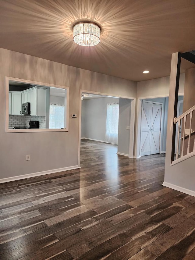 interior space with a chandelier and dark hardwood / wood-style floors