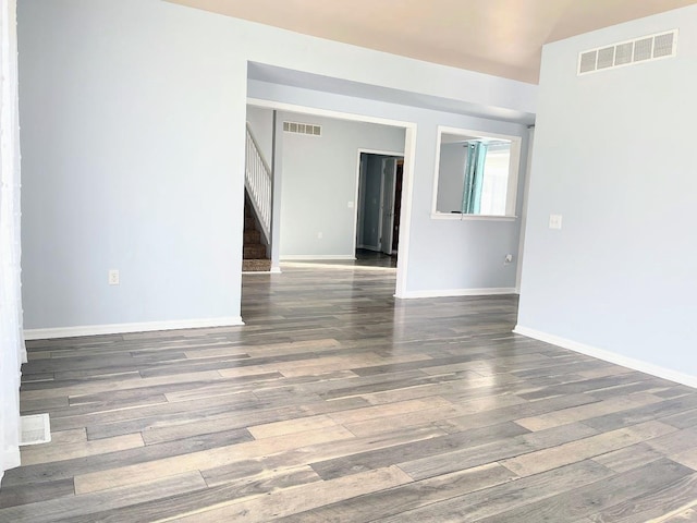 spare room with dark wood-type flooring