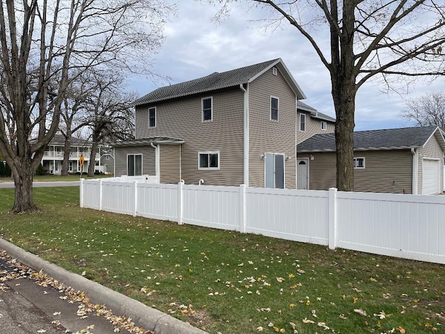 view of side of property with a garage and a yard