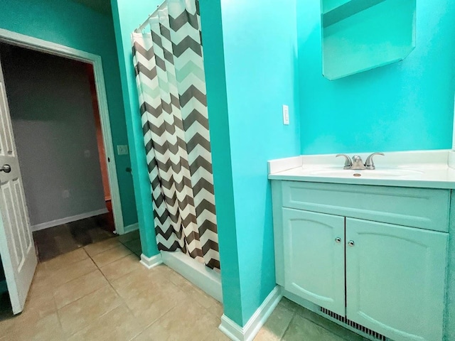 bathroom with a shower with curtain, vanity, and tile patterned floors