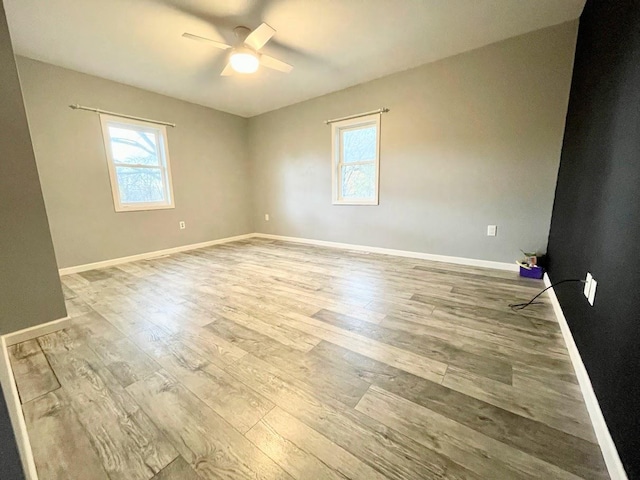 spare room with light hardwood / wood-style floors and ceiling fan