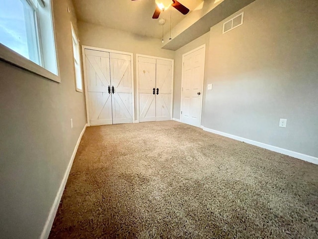 unfurnished bedroom with ceiling fan and carpet floors