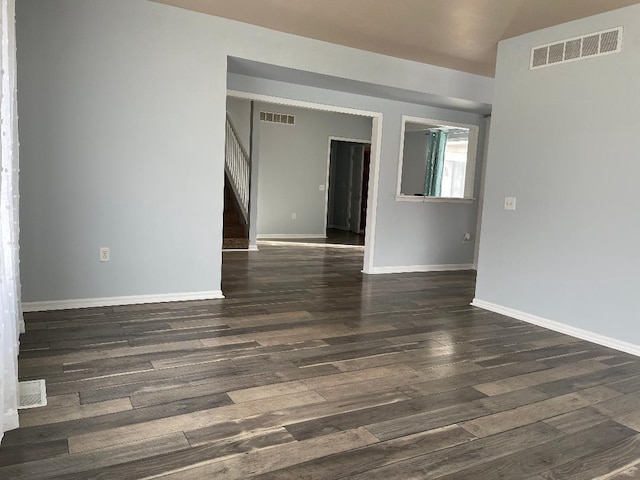 unfurnished room featuring dark wood-type flooring