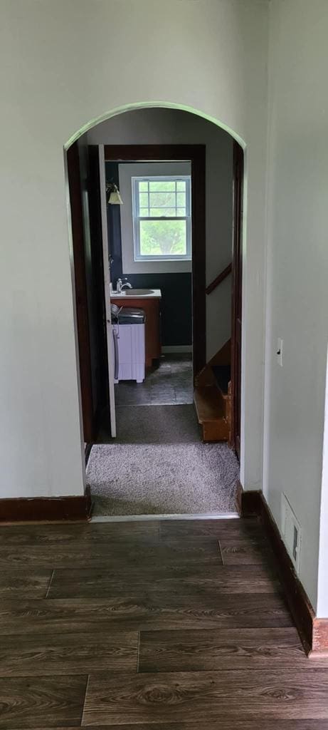 hallway with dark wood-type flooring