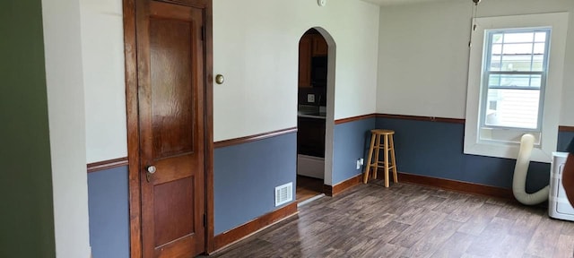 unfurnished room with dark hardwood / wood-style floors