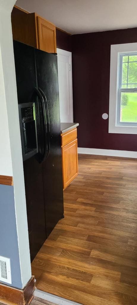 kitchen featuring black fridge and light hardwood / wood-style floors