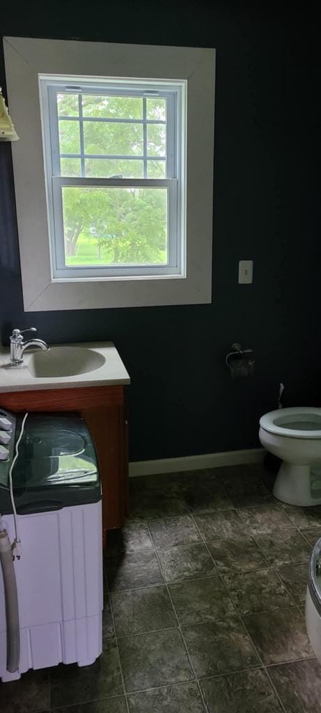 bathroom with vanity, a wealth of natural light, and toilet