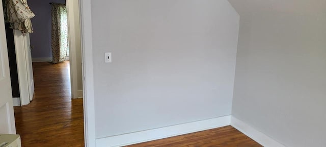 hallway with dark wood-type flooring