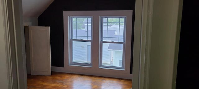 entryway with lofted ceiling and light hardwood / wood-style floors