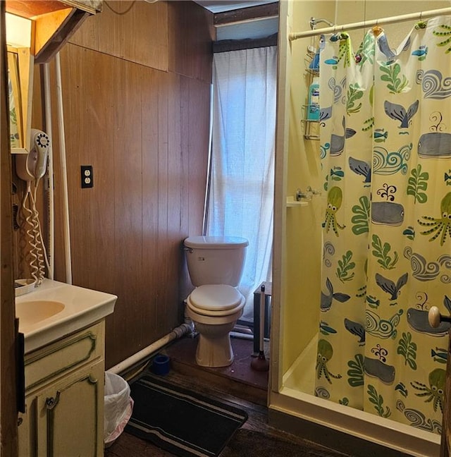 bathroom featuring toilet, wooden walls, vanity, and a shower with shower curtain