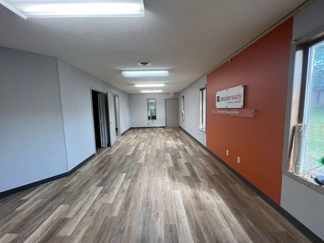 1802 Talen St, Menomonie, WI 54751 - spare room featuring wood finished floors, baseboards, and a textured ceiling